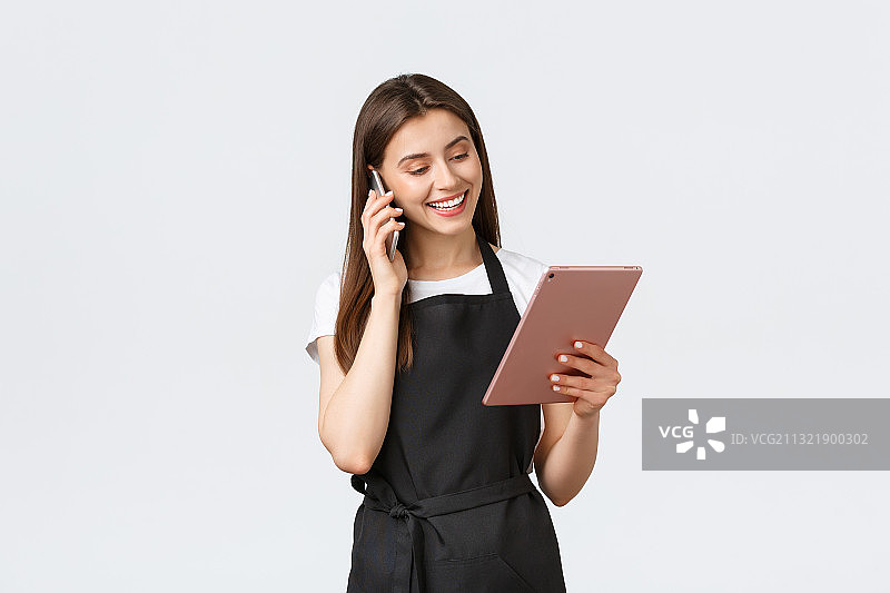 靠在白色背景上使用平板电脑的微笑年轻女商人图片素材