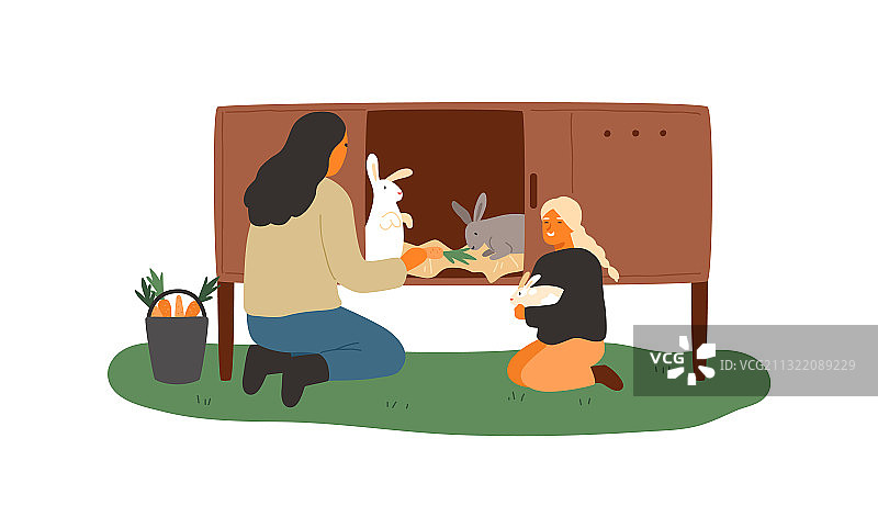 母女在笼子里喂兔子图片素材