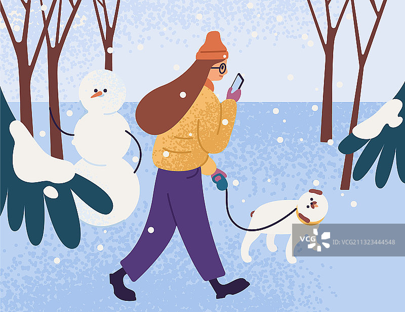 穿着保暖外套在公园里遛狗的年轻女人图片素材