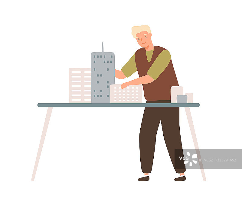 年轻男建筑师安装迷你城市建筑图片素材