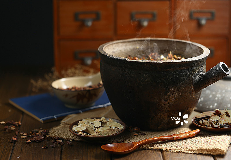 中药砂锅和中药碟子放在深色背景上图片素材
