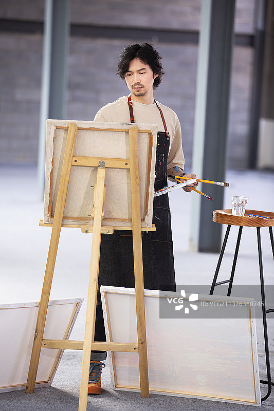 画家在工作室画油画图片素材