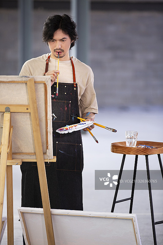 画家在工作室画油画图片素材
