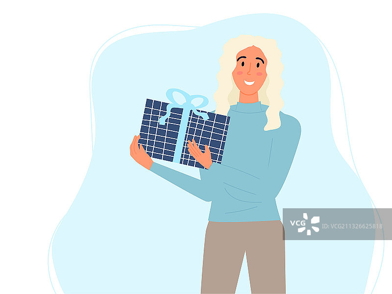 手持礼品盒的快乐金发年轻女人图片素材