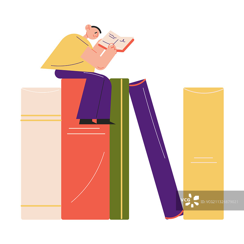 快乐的年轻男孩坐在彩色书本上图片素材