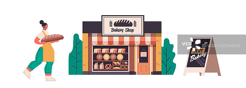 穿制服的女面包师拿着烘焙面包图片素材