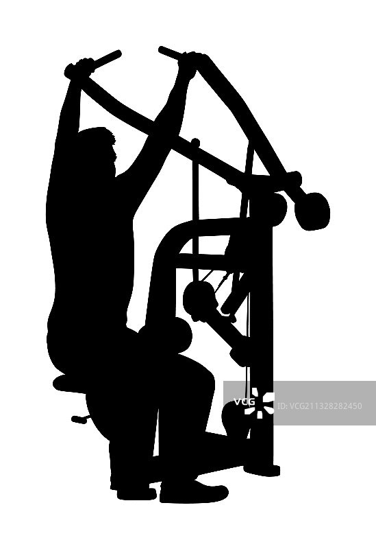 男人在健身房的健身器材上锻炼图片素材