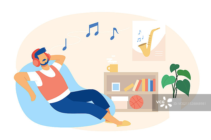 男人在客厅的懒人沙发上带着耳机听音乐图片素材