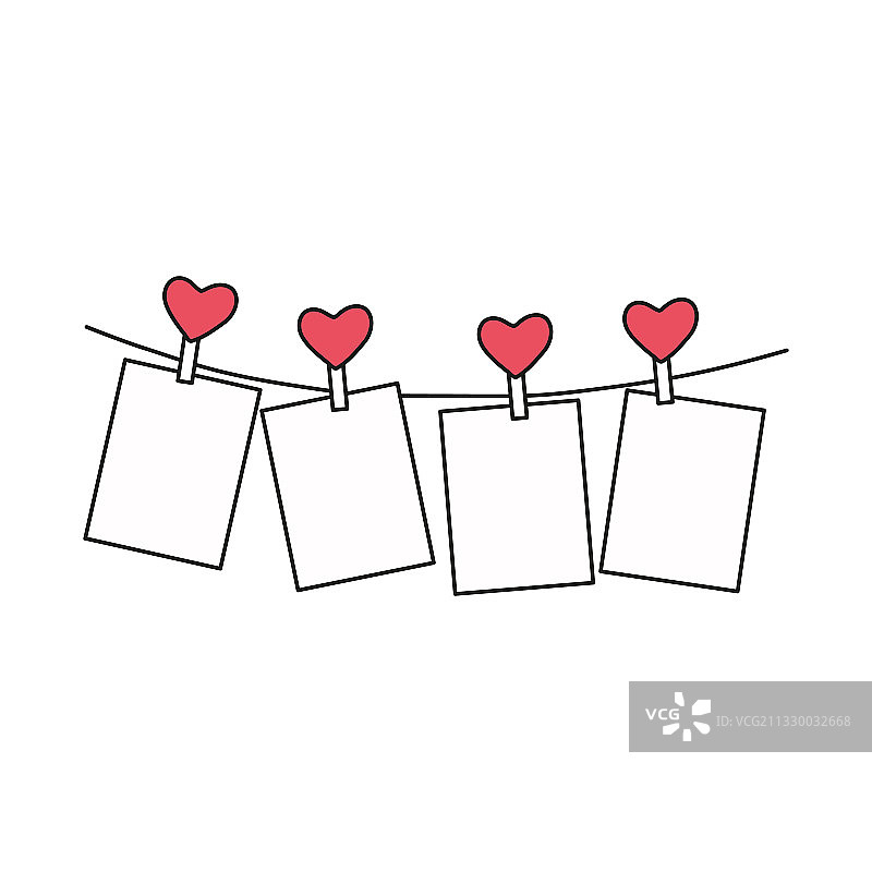 白色背景上用衣夹夹住的爱心照片图片素材