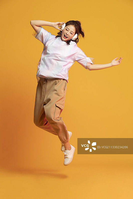 快乐的年轻女孩听音乐图片素材