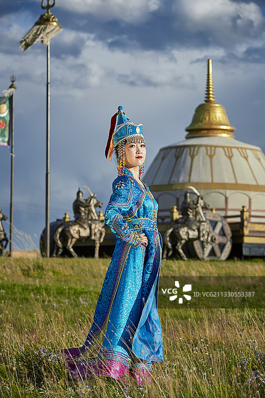 草原上蒙古包前穿着蒙古族传统服饰的少女图片素材