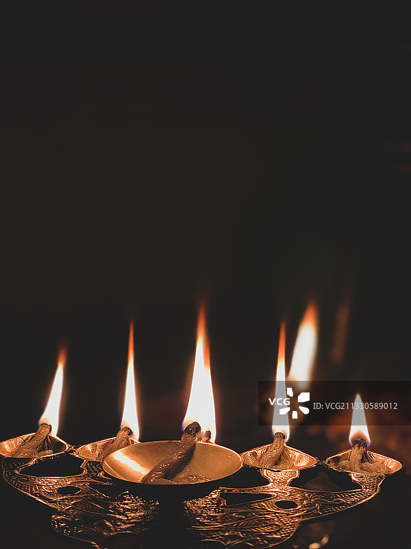 黑暗房间里燃烧的油灯特写，尼泊尔图片素材