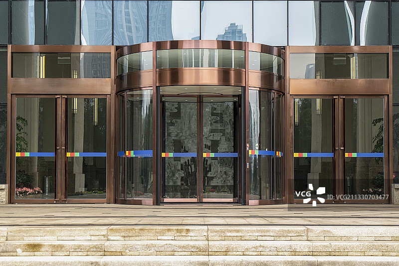 城市现代办公写字楼旋转玻璃门图片素材