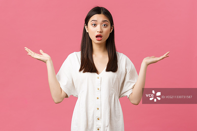 年轻女子在粉色背景下手势的肖像图片素材