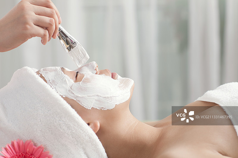 美容师在水疗中心为顾客敷面膜图片素材