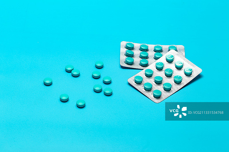蓝色药片放在蓝色背景上图片素材