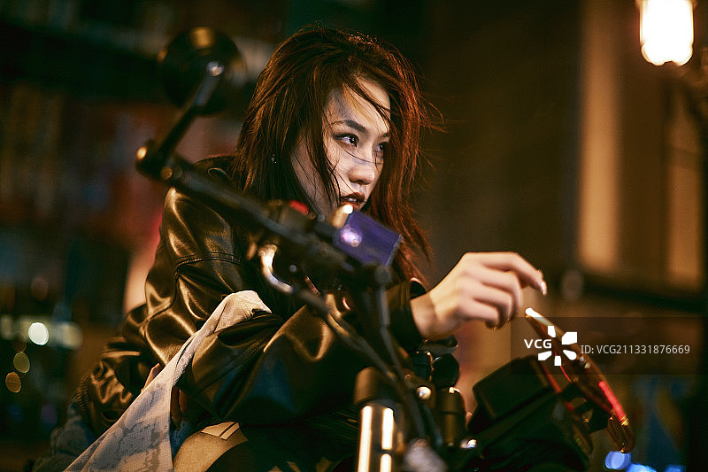 夜晚霓虹下骑摩托的少女图片素材