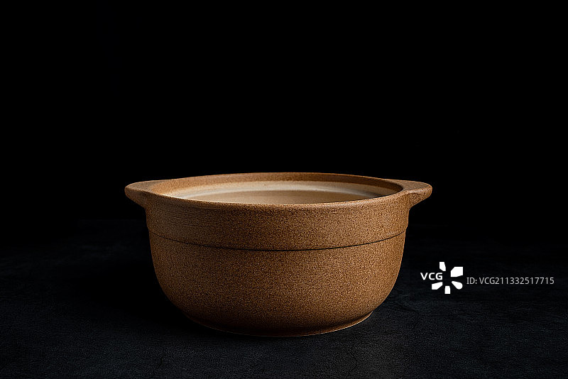 一个砂锅在黑色背景上图片素材