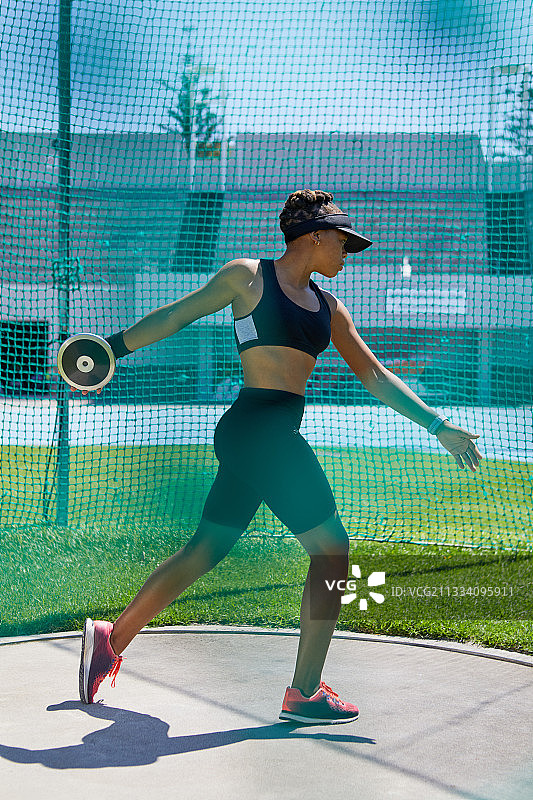 田径女运动员掷铁饼图片素材