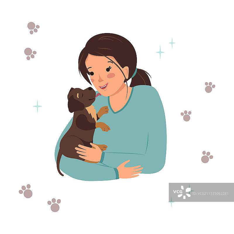 女士抱着一只拉布拉多幼犬图片素材