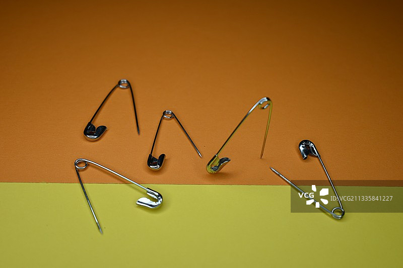 紫色背景上的安全别针特写图片素材