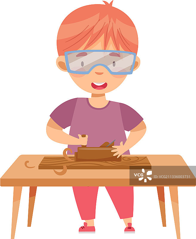 桌旁戴防护眼镜的小红发男孩图片素材