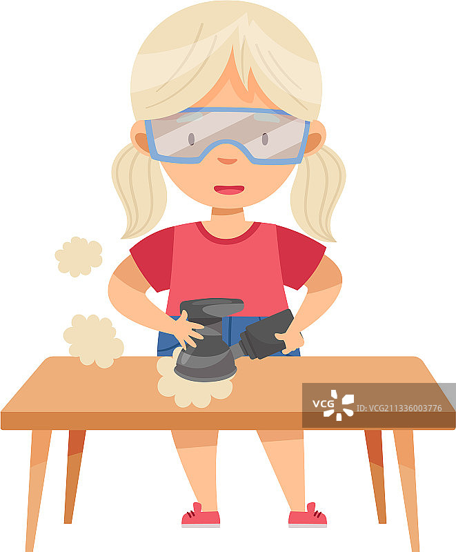 戴防护镜的金发小女孩在桌旁图片素材