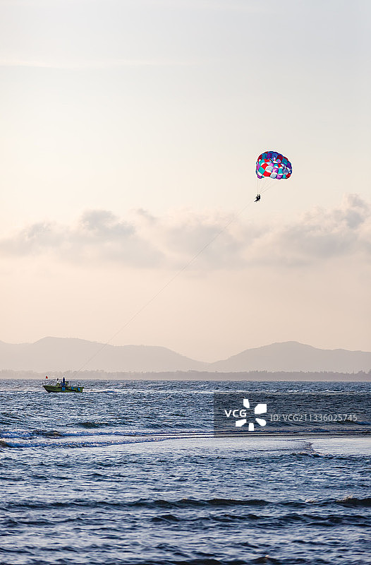 黄昏时侯海边双人旅游拖伞图片素材