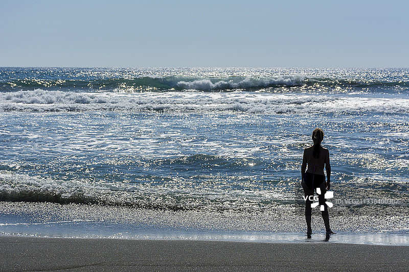 科利马，墨西哥：站在海滩岸边的女子背影图片素材
