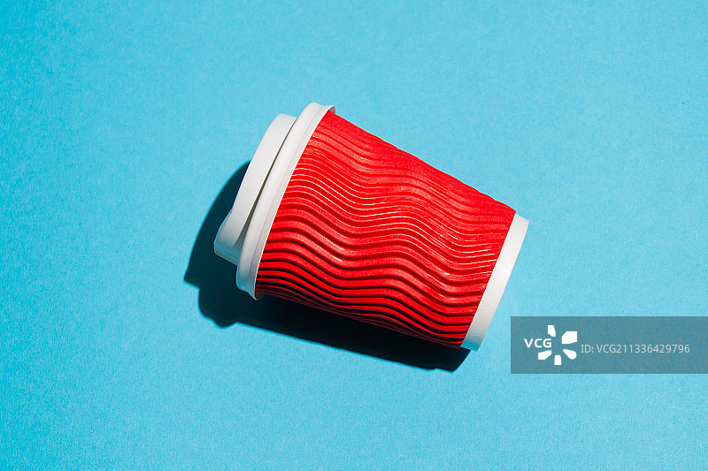 蓝色背景上的外带红色纸咖啡或茶杯图片素材