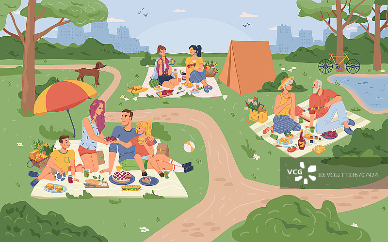 城市公园和坐在草地上野餐的人们图片素材