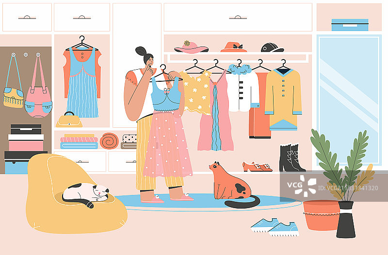 女人在打开的衣柜旁挑选服装图片素材