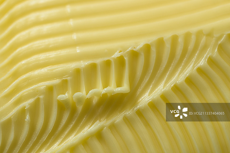 带有纹理背景的黄油特写图片素材