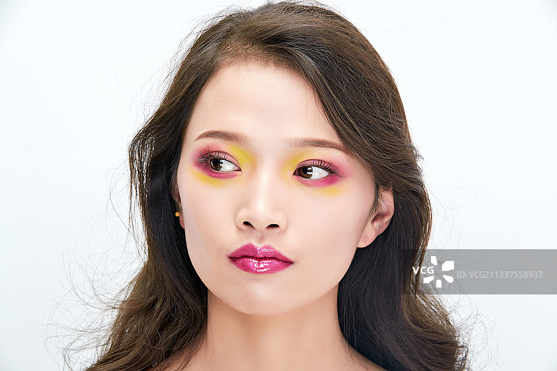 白色背景下棚拍化妆中的美女图片素材