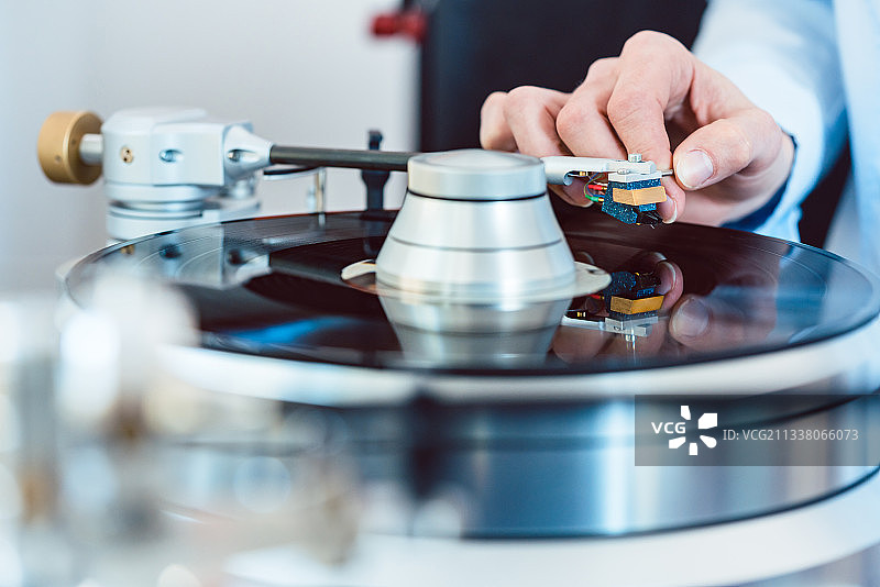 在唱片转盘上放唱针的女人图片素材