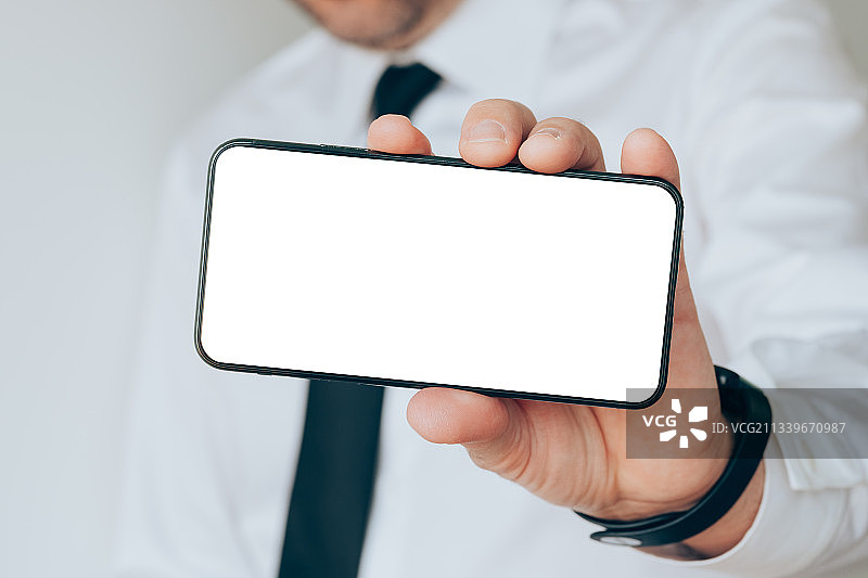 商人拿着手机的中段照片，塞尔维亚图片素材