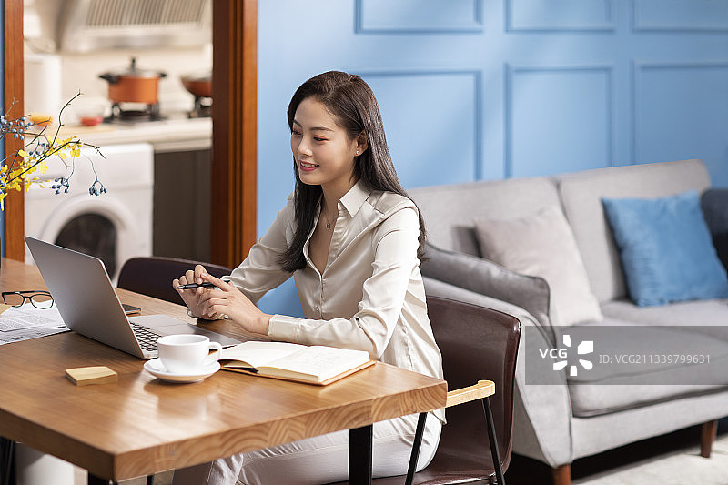 年轻女子在家远程办公图片素材
