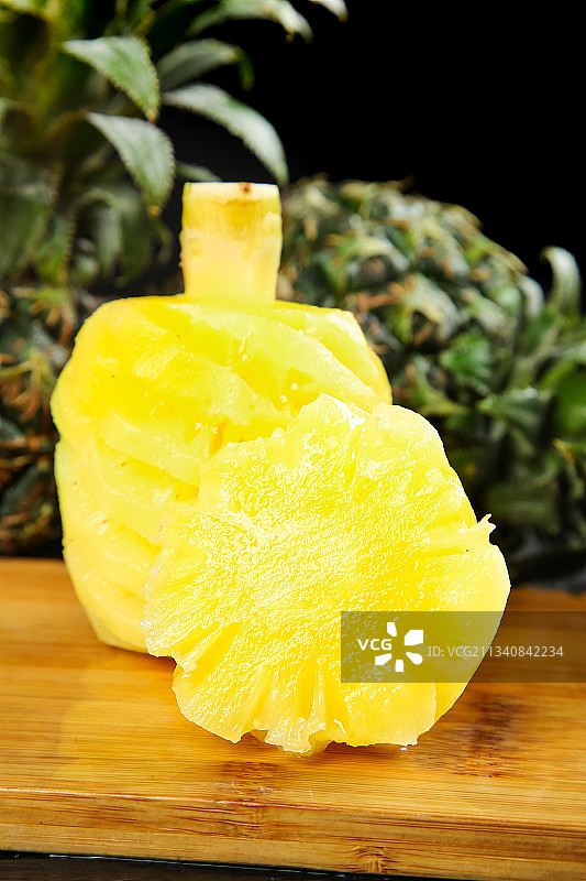 木板上放着泰国去皮小菠萝图片素材