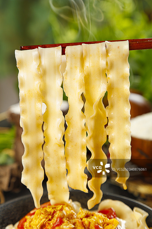 木底上放着一碗西红柿鸡蛋刀削面图片素材