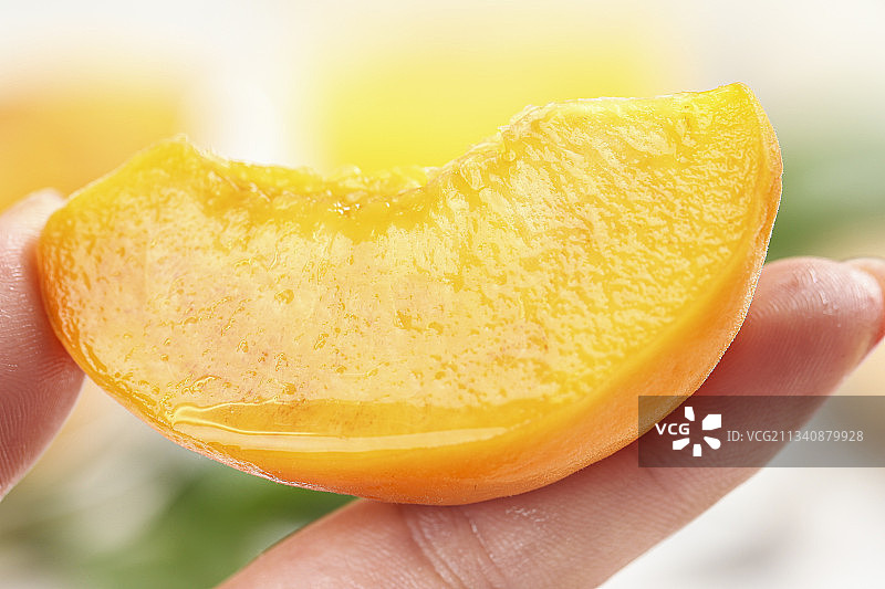 手里拿着新鲜黄桃图片素材