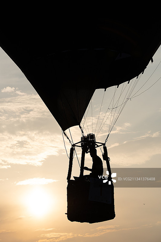 波兰日落天空下滑翔伞男人剪影图片素材