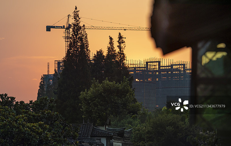 远处的现代建筑工地和近处的乌镇古风建筑图片素材
