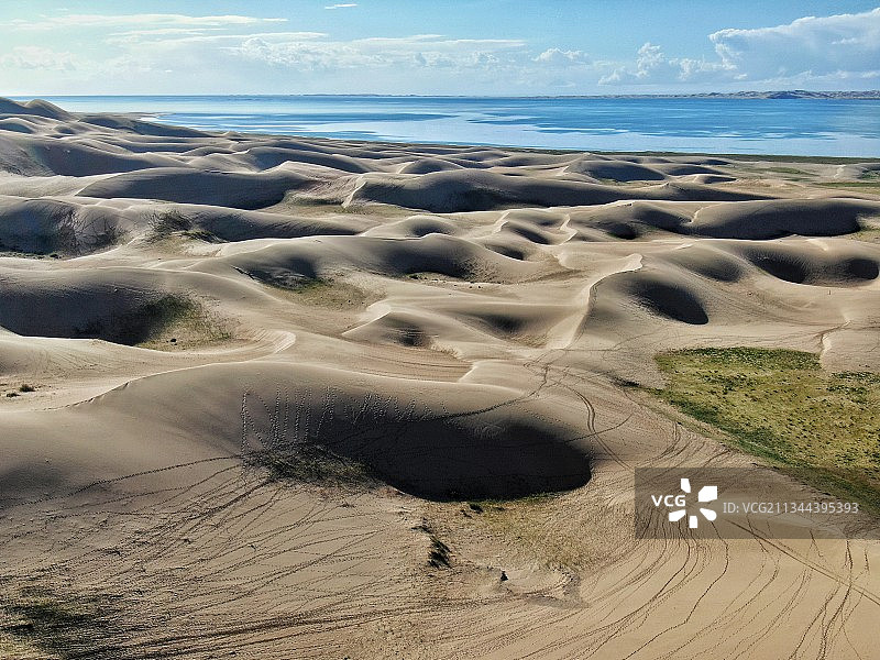 青海湖金沙湾，以观看金色的沙漠风光为主要特色，沙丘背后的蔚蓝图片素材