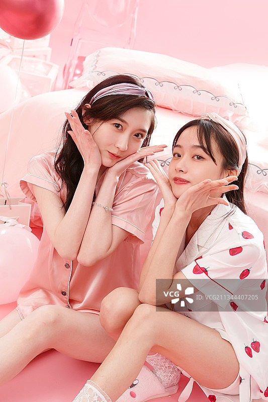 卧室内快乐玩耍的年轻闺蜜图片素材