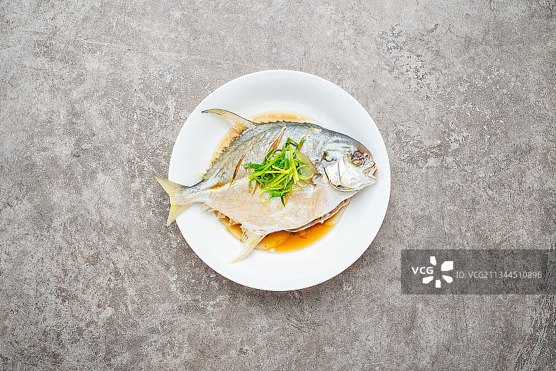 水泥背景上一碟美味的清蒸金昌鱼图片素材