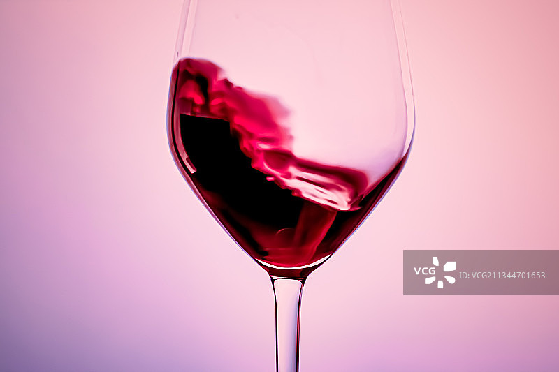 红色背景下的葡萄酒杯特写图片素材