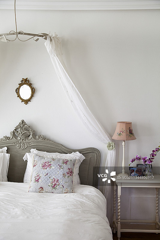 卧室内的带床冠的双人床图片素材