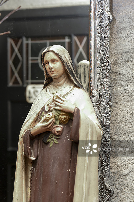 带华丽镜框的镜子前的老圣母雕像图片素材