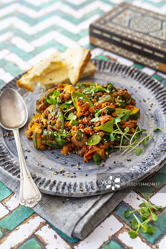 扁豆、西葫芦、糖豌豆和菠菜纯素咖喱菜肴图片素材