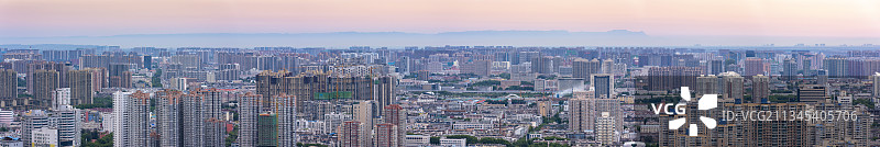 日出时分河南省郑州市城市全景及远处清晰可见的新乡太行山脉图片素材